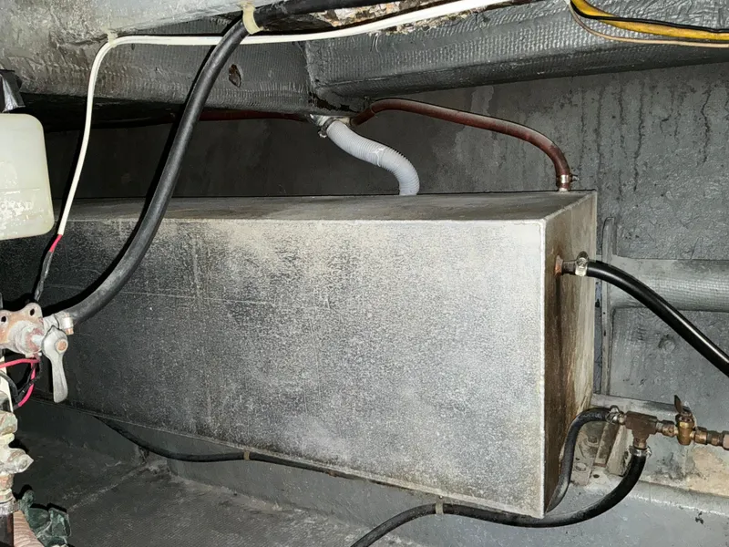 Slide: The Image of 1978 Californian 34 LRC engine compartment with metal tank and connected hoses. - 40