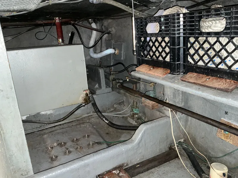 Slide: The Image of 1978 Californian 34 LRC engine room with storage crates and mechanical components. - 49