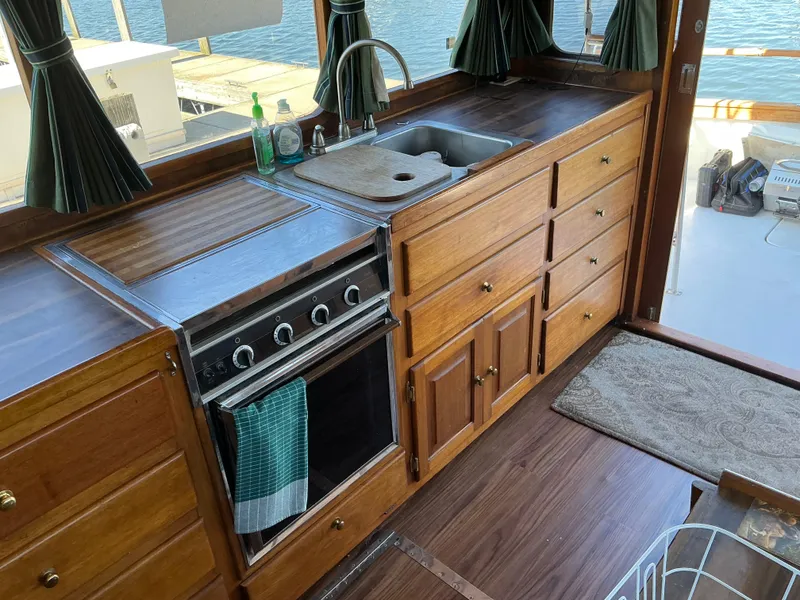 Slide: The Image of 1978 Californian 34 LRC yacht kitchen with wooden cabinets and stainless steel appliances. - 6