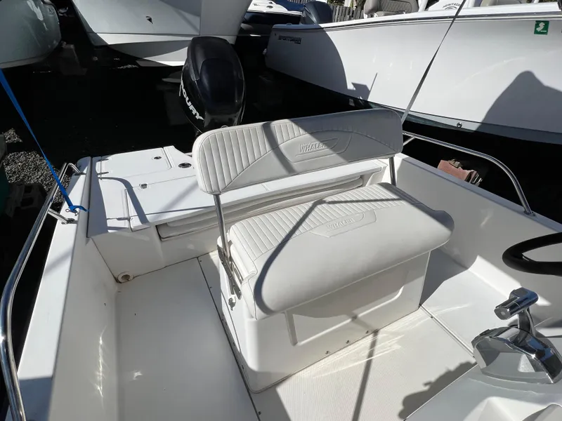 Slide: The Image of 2008 Boston Whaler 210 Dauntless boat interior with seating and steering console. - 10