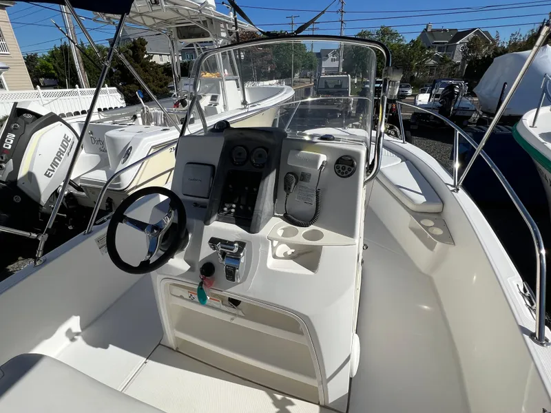 Slide: The Image of 2008 Boston Whaler 210 Dauntless boat interior with steering console and controls. - 11