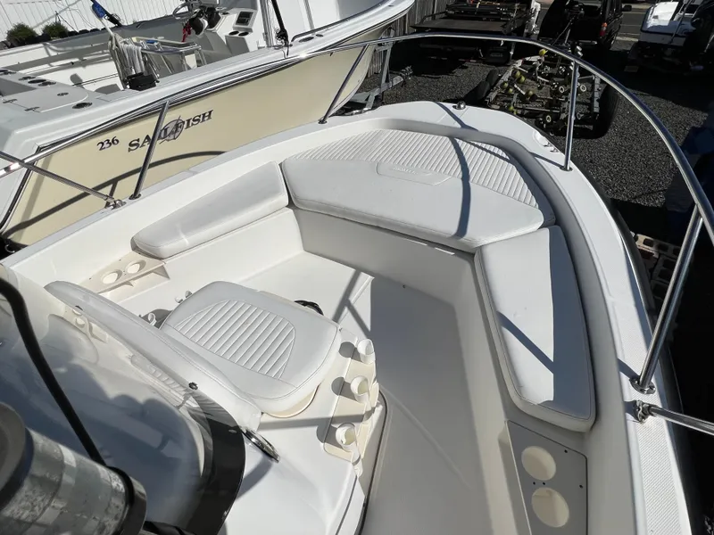 Slide: The Image of 2008 Boston Whaler 210 Dauntless boat interior with cushioned seating and railings. - 15