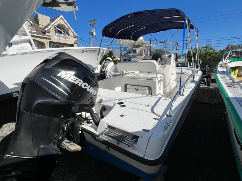 Slide: The Image of 2008 Boston Whaler 210 Dauntless boat with Mercury outboard motor and blue canopy. - 3