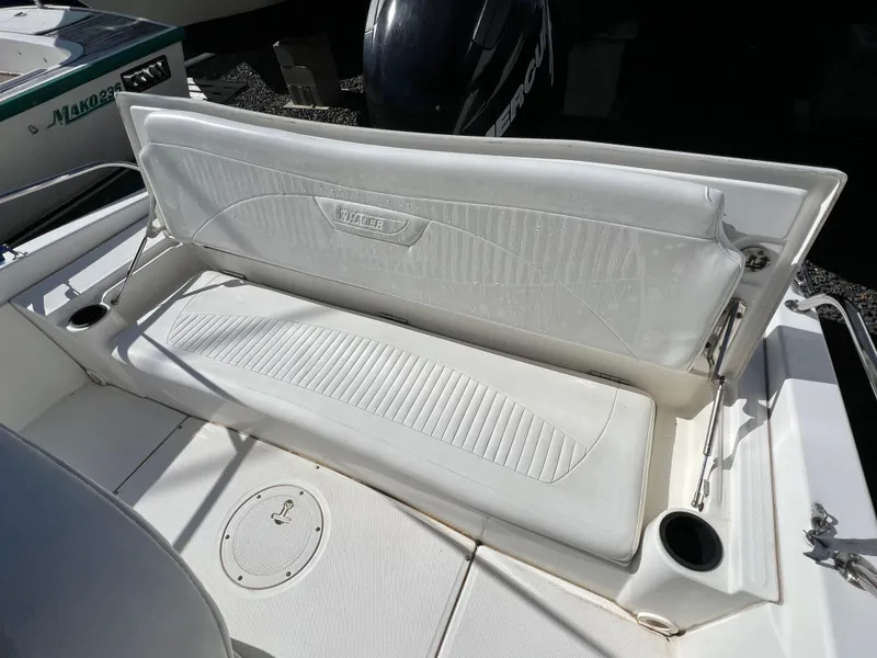 Slide: The Image of 2008 Boston Whaler 210 Dauntless boat seat with white upholstery and cup holders. - 8