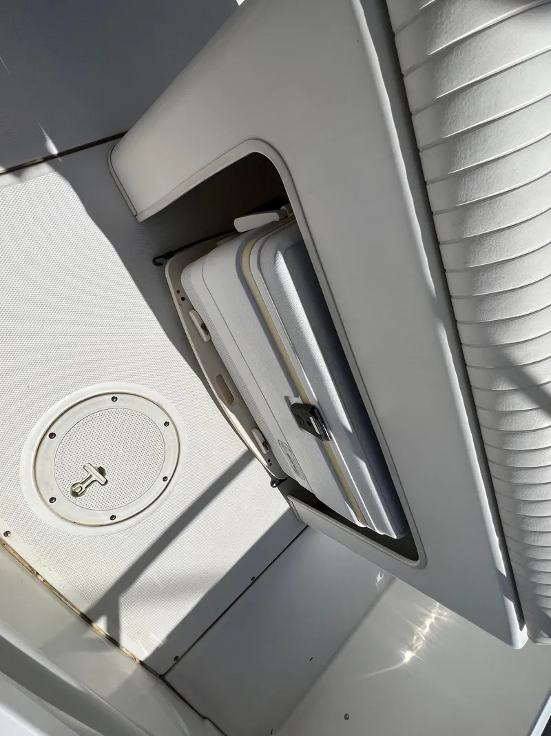 Slide: The Image of 2008 Boston Whaler 210 Dauntless interior with storage compartment and seating. - 9