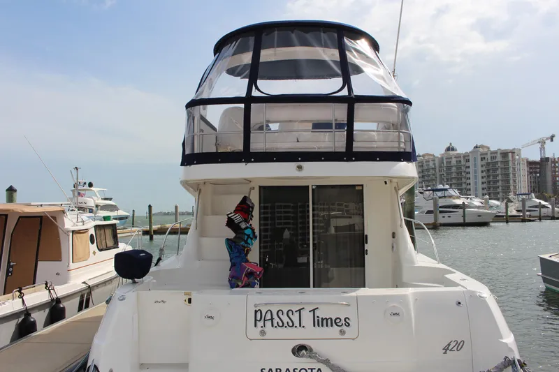 Slide: The Image of 2005 Sea Ray 420 Sedan Bridge docked at marina with cityscape background. - 0