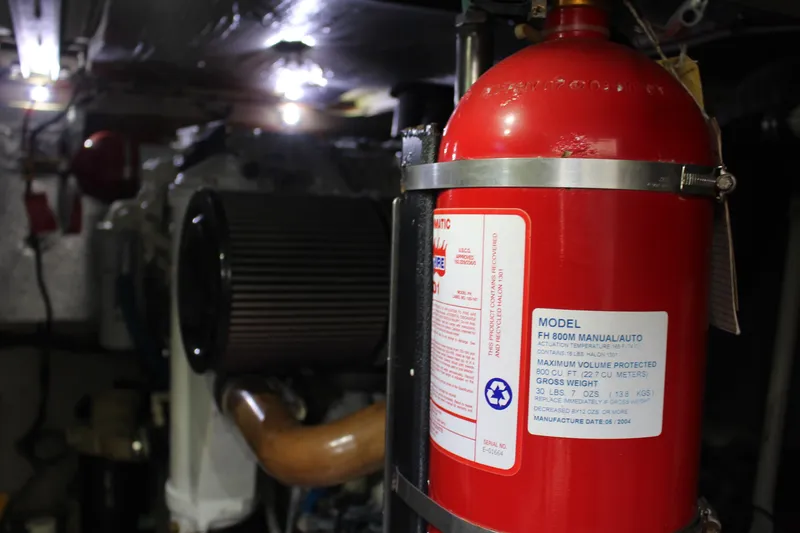 Slide: The Image of Engine room of 2005 Sea Ray 420 Sedan Bridge with fire extinguisher. - 24