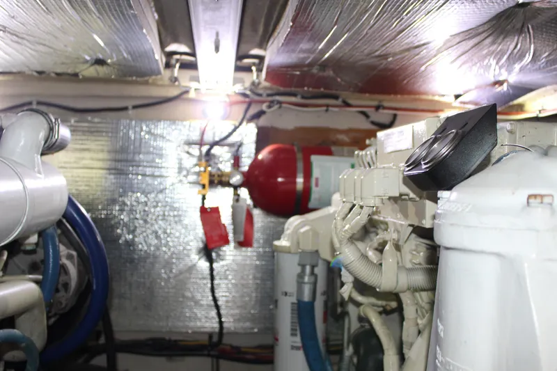 Slide: The Image of Engine room of 2005 Sea Ray 420 Sedan Bridge with visible machinery and insulation. - 25