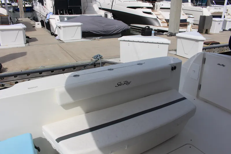 Slide: The Image of 2005 Sea Ray 420 Sedan Bridge boat docked, featuring a white seating area. - 3
