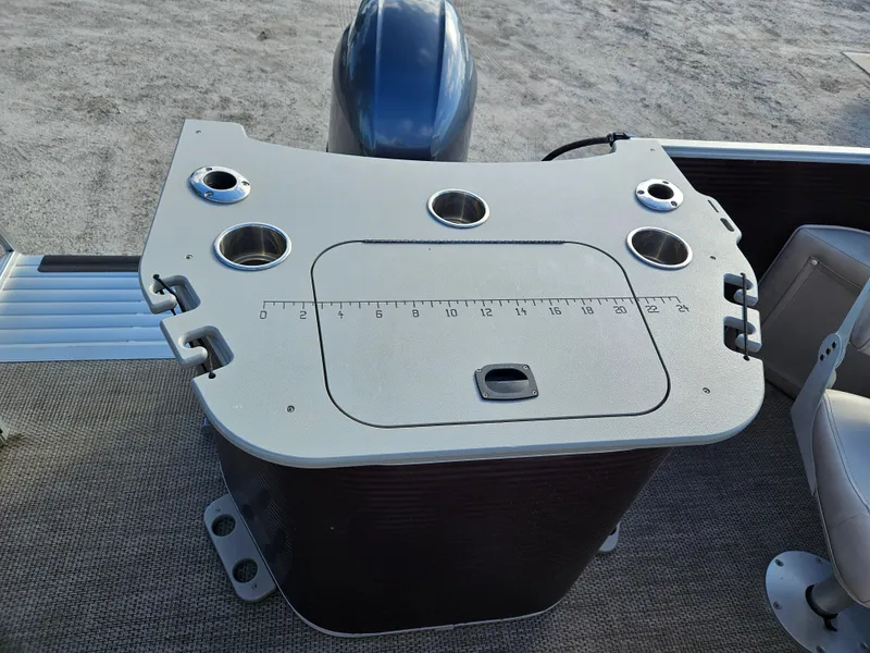 Slide: The Image of 2019 Bennington 20 SX boat console with cup holders and measurement markings. - 10