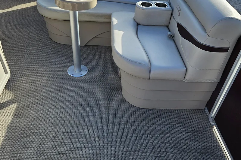 Slide: The Image of 2019 Bennington 20 SX boat interior with cushioned seating and cup holders. - 11