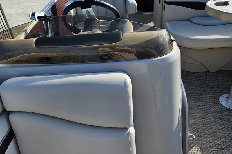 Slide: The Image of 2019 Bennington 20 SX boat interior with steering console and seating area. - 12