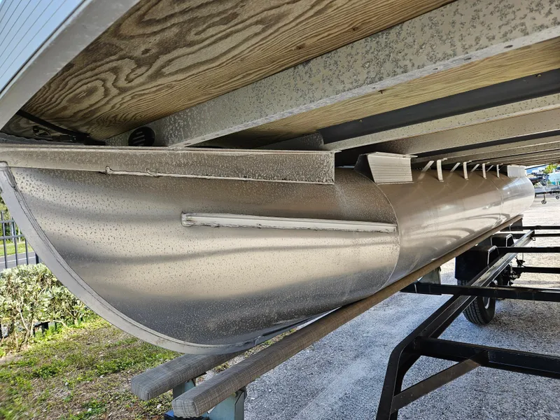 Slide: The Image of 2019 Bennington 20 SX pontoon boat underside on trailer, showcasing aluminum construction. - 20