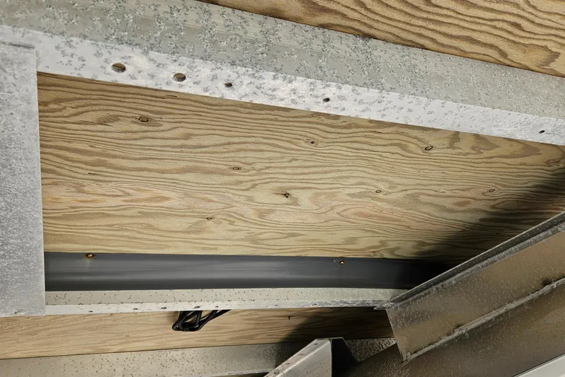 Slide: The Image of Underneath view of 2019 Bennington 20 SX boat showing wooden and metal construction. - 24