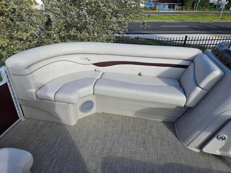 Slide: The Image of 2019 Bennington 20 SX boat interior with beige seating and speaker. - 8
