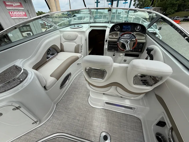 Slide: The Image of 2023 Crownline 270 CR boat interior with modern helm and seating. - 11