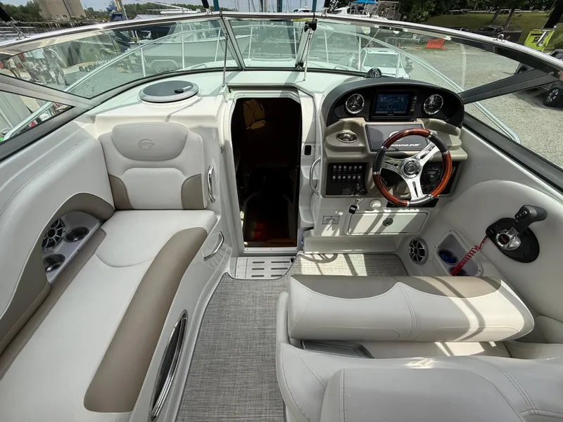 Slide: The Image of 2023 Crownline 270 CR boat interior with plush seating and modern dashboard controls. - 12