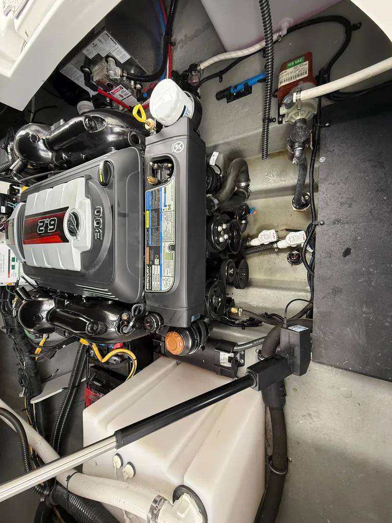 Slide: The Image of Engine compartment of a 2023 Crownline 270 CR boat, showcasing detailed mechanical components. - 20