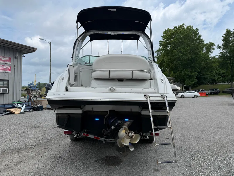 Slide: The Image of 2023 Crownline 270 CR boat, rear view with ladder, parked outdoors. - 23