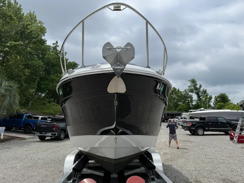 Slide: The Image of 2023 Crownline 270 CR boat on trailer, front view, parked outdoors. - 4