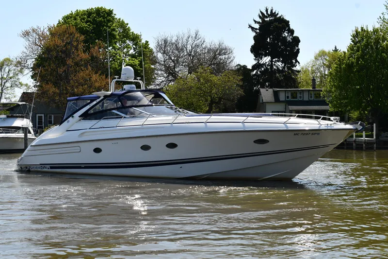 The Image of 1996 Sunseeker Camargue 51 yacht cruising on a calm river near lush greenery. - 0