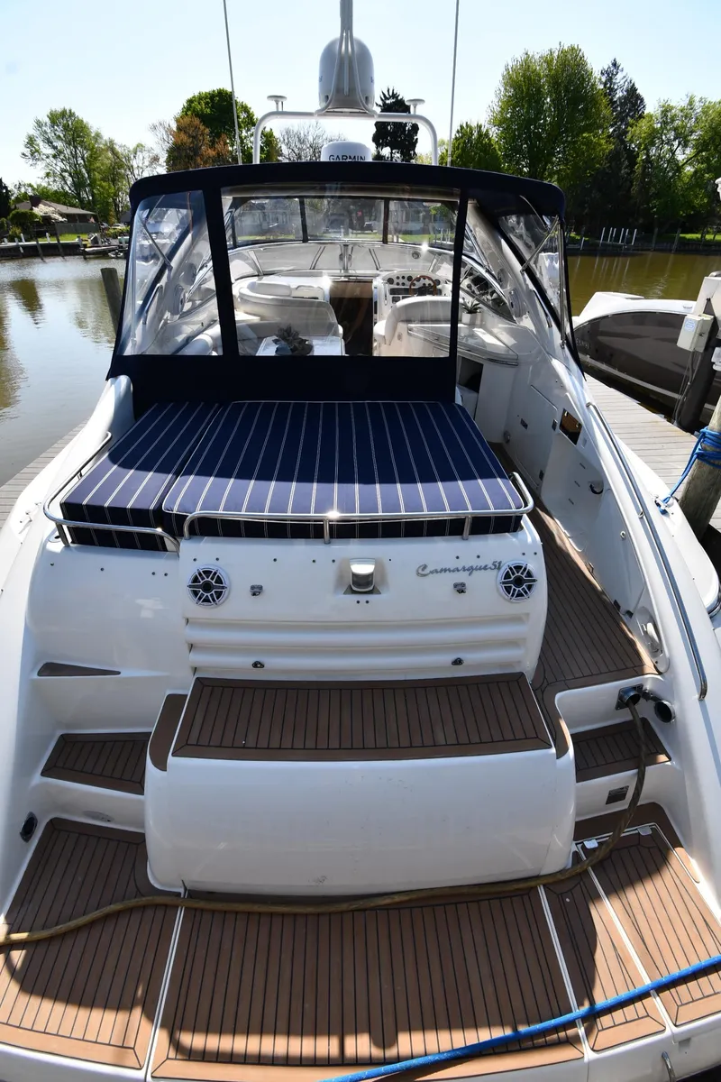 Slide: The Image of 1996 Sunseeker Camargue 51 yacht docked, featuring spacious deck and sleek design. - 11