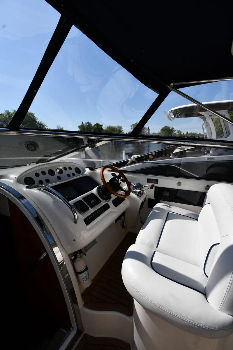 Slide: The Image of Interior view of 1996 Sunseeker Camargue 51 yacht cockpit with white seating and control panel. - 15