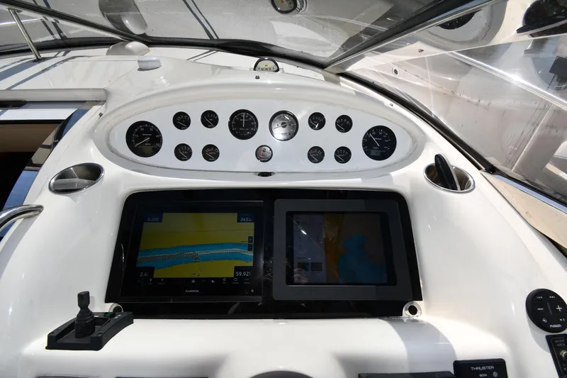 Slide: The Image of 1996 Sunseeker Camargue 51 yacht dashboard with navigation screens and gauges. - 16