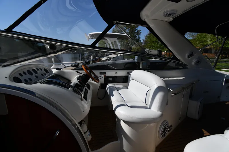 Slide: The Image of Interior of 1996 Sunseeker Camargue 51 yacht with white seating and wooden steering wheel. - 20