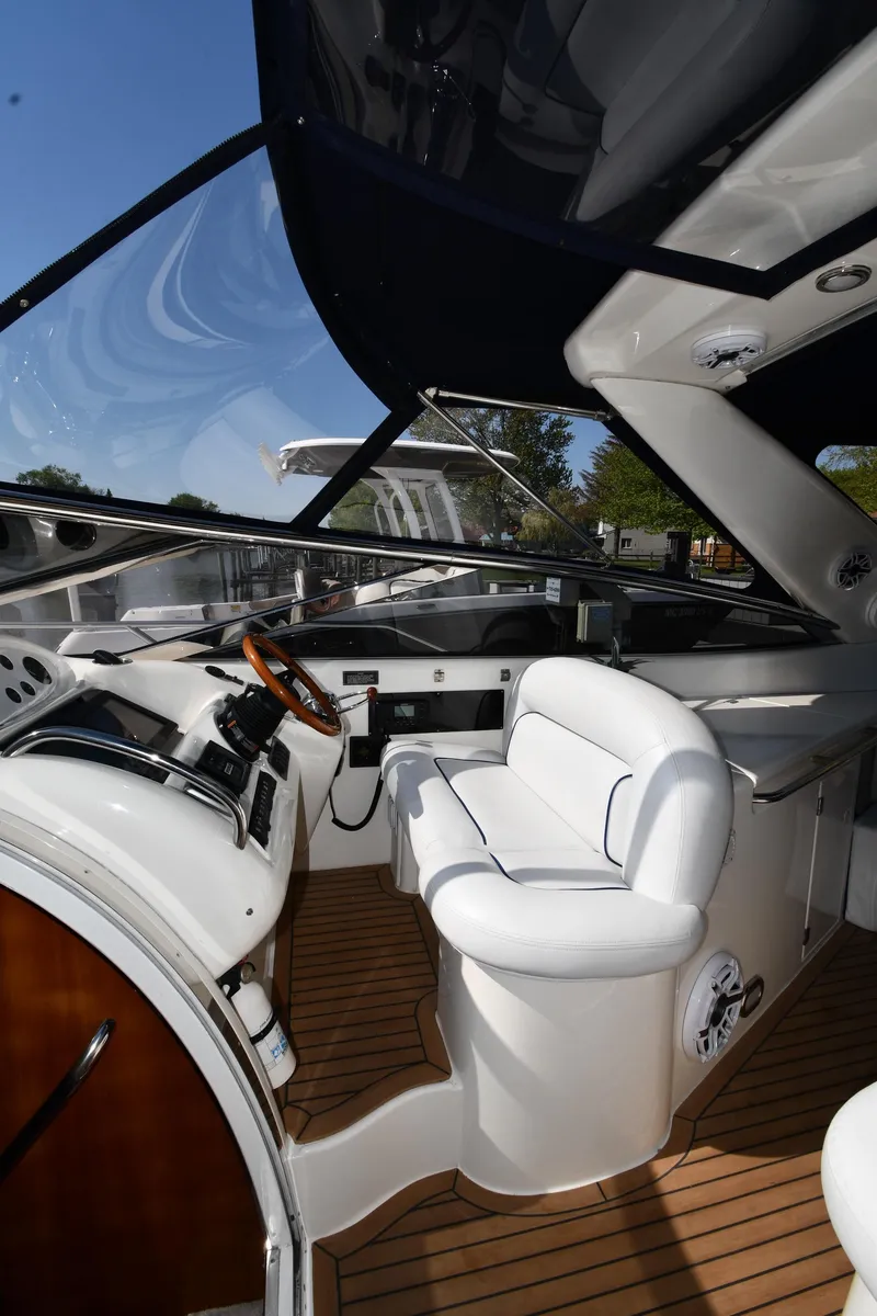 Slide: The Image of Interior view of 1996 Sunseeker Camargue 51 yacht cockpit with white seating and wooden accents. - 21