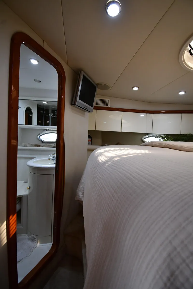 Slide: The Image of Interior of 1996 Sunseeker Camargue 51 yacht, featuring a cozy bedroom and bathroom. - 37