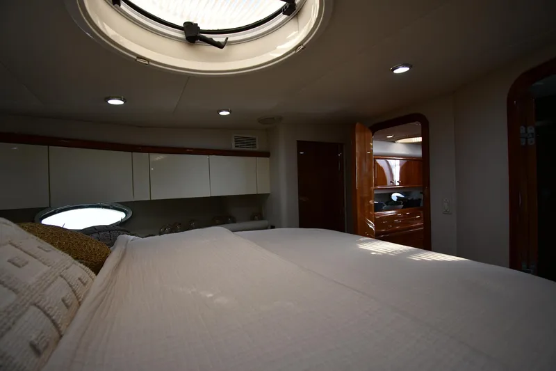 Slide: The Image of Interior cabin of 1996 Sunseeker Camargue 51 yacht, featuring a cozy bed and elegant wood finishes. - 39