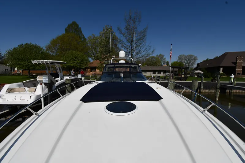Slide: The Image of 1996 Sunseeker Camargue 51 yacht docked, showcasing sleek design and spacious deck. - 7
