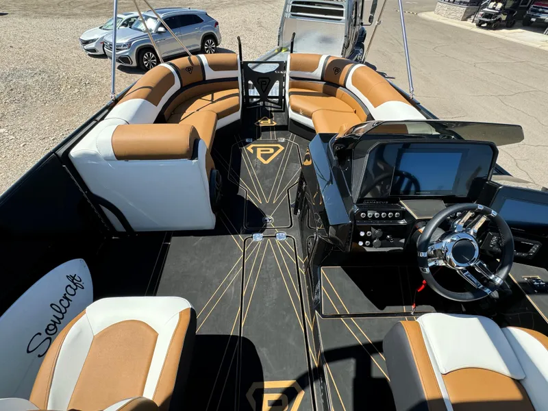 Slide: The Image of 2025 Paradigm 236 Surf SL boat interior with luxurious seating and modern dashboard. - 9