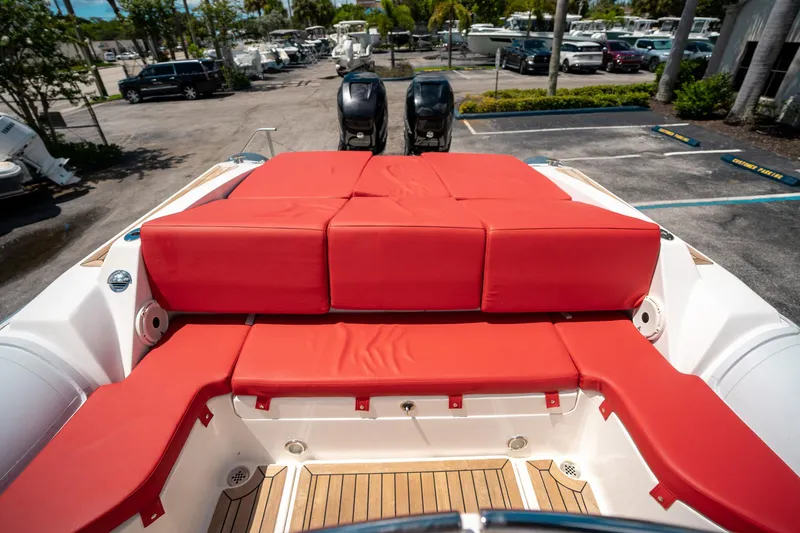 Slide: The Image of Red cushioned seating on a 2015 Pirelli 1100 boat, parked in a marina. - 23