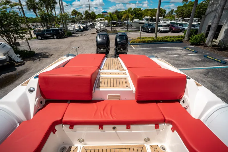 Slide: The Image of Red cushioned deck of 2015 Pirelli 1100 boat with dual engines in a marina. - 24