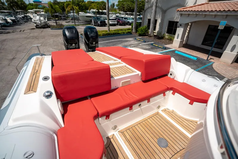 Slide: The Image of Pirelli 1100 boat, 2015 model, featuring red seating and teak flooring in a marina setting. - 26