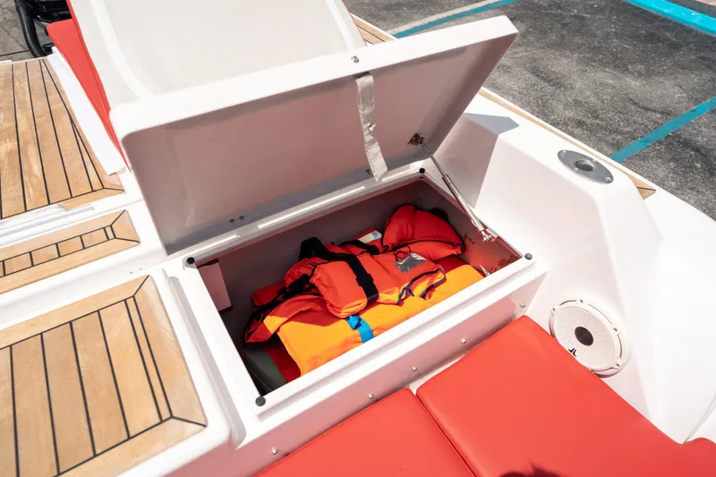 Slide: The Image of Open storage compartment on 2015 Pirelli 1100 boat with life jackets inside. - 28
