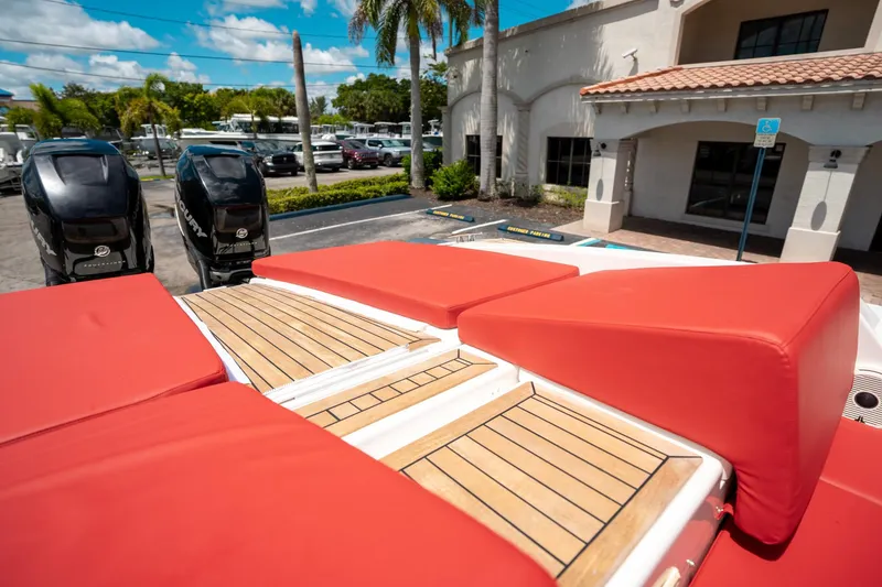 Slide: The Image of Red-cushioned deck of 2015 Pirelli 1100 boat with twin Mercury engines. - 31