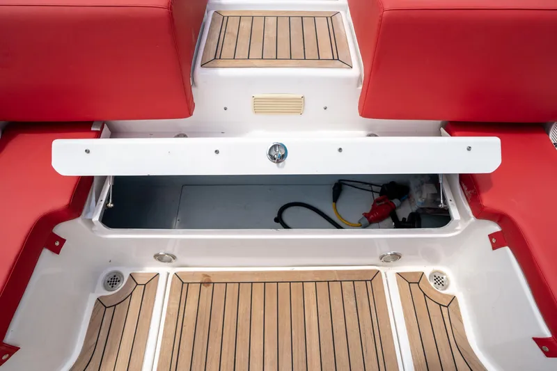 Slide: The Image of 2015 Pirelli 1100 boat interior with red seats and wooden flooring. - 32