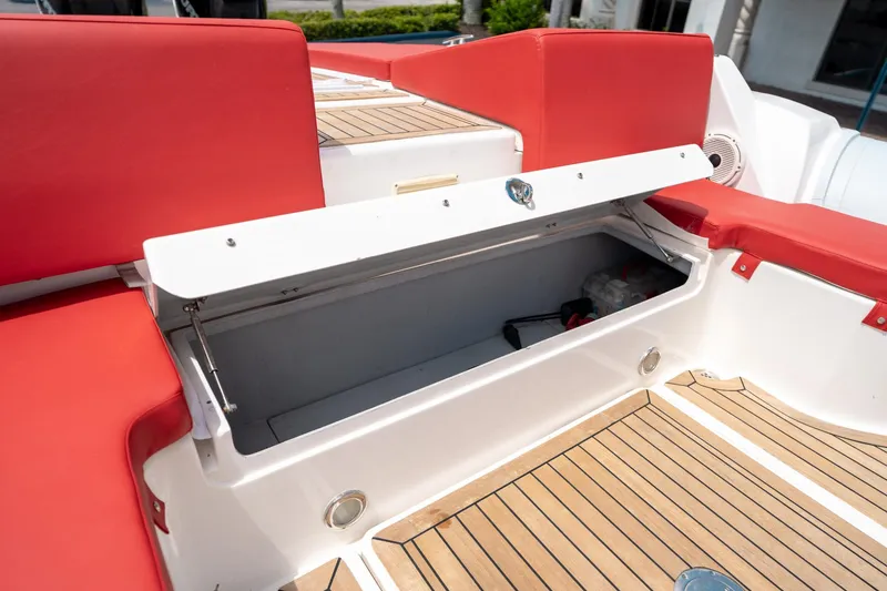 Slide: The Image of Open storage compartment on 2015 Pirelli 1100 boat with red seating and wooden deck. - 34