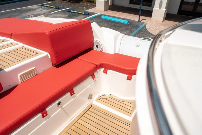 Slide: The Image of Red cushioned seating on 2015 Pirelli 1100 boat deck, featuring teak flooring. - 36