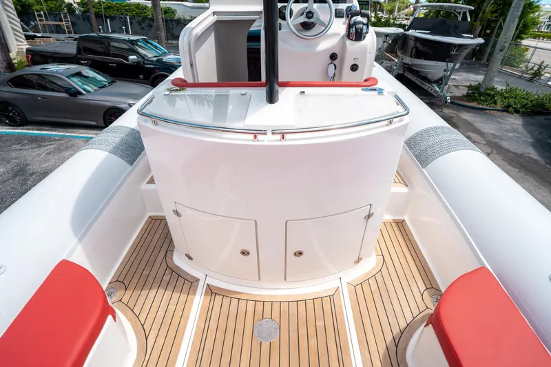 Slide: The Image of 2015 Pirelli 1100 boat interior with red accents and wooden deck. - 37