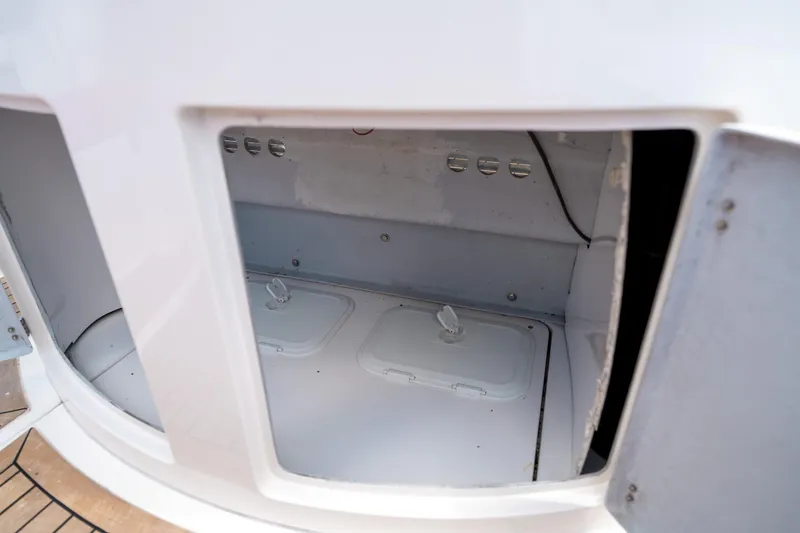 Slide: The Image of Open storage compartment on a 2015 Pirelli 1100 boat, featuring white interior and access hatches. - 41