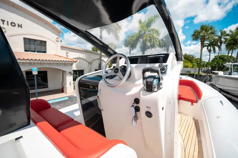 Slide: The Image of Pirelli 1100 boat interior with red seating, steering wheel, and control panel, 2015 model. - 47