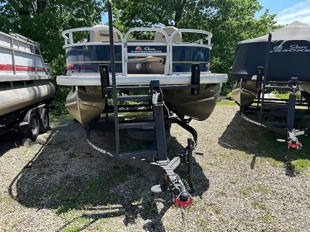 Slide: The Image of 2023 Sun Tracker Bass Buggy 16 XL Select pontoon boat on trailer, parked outdoors. - 17