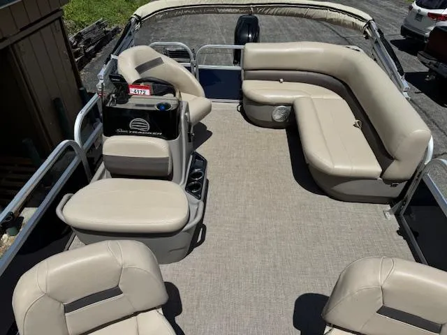 Slide: The Image of 2023 Sun Tracker Bass Buggy 16 XL Select pontoon boat with beige seating and spacious deck. - 2