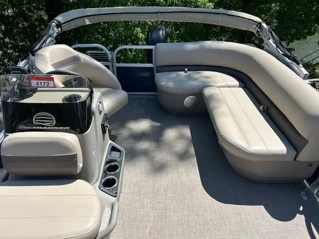 Slide: The Image of 2023 Sun Tracker Bass Buggy 16 XL Select pontoon boat interior with beige seating and helm. - 21