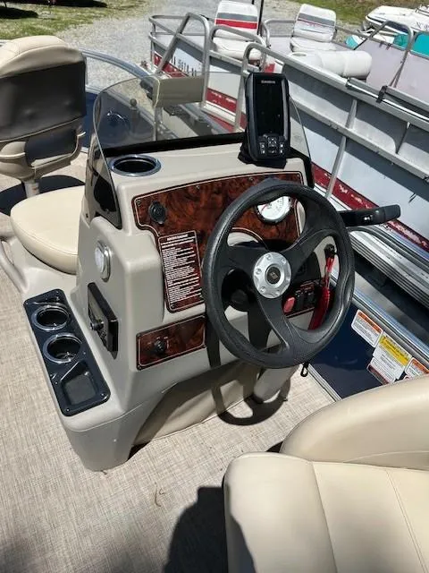Slide: The Image of 2023 Sun Tracker Bass Buggy 16 XL Select boat console with steering wheel and navigation system. - 22