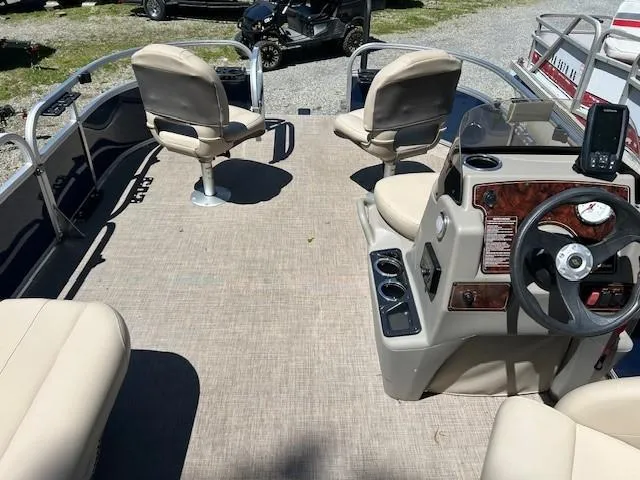 Slide: The Image of 2023 Sun Tracker Bass Buggy 16 XL Select pontoon boat interior with seating and steering console. - 23